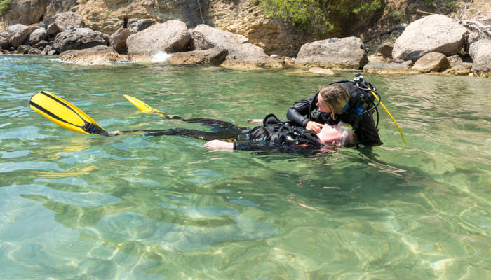 Diver checks casualty for breathing during a rescue practice